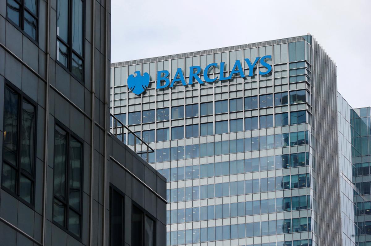 Climate activists spray 'fake oil' onto Barclays HQ in London's Canary Wharf